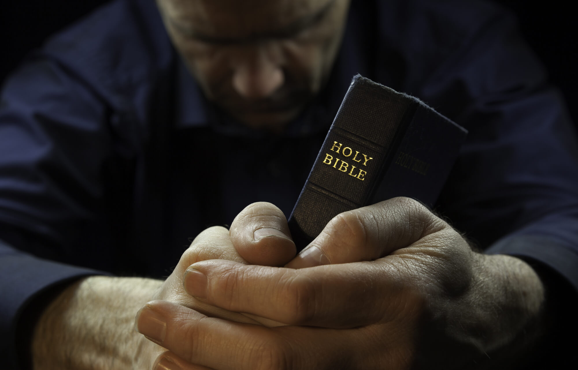 A Man Holding A Holy Bible.
